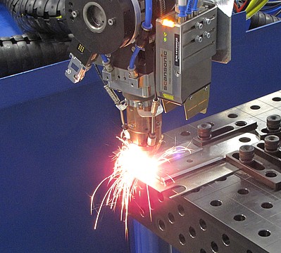 Laserové robotické navařování kovových dílů a prášků.